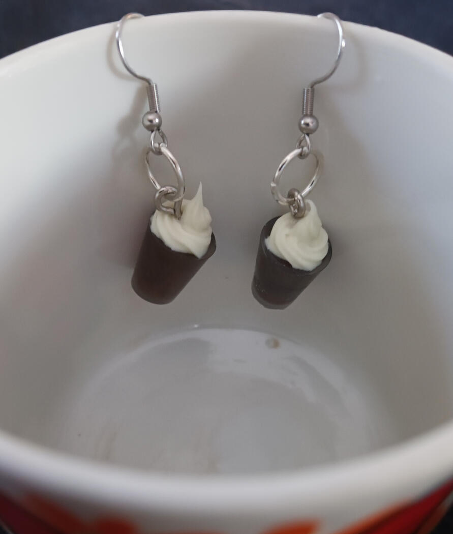 Dangle coffee-shaped earrings colored with brown mica powder. Fake whipped cream on top made out of piped decoden glue.