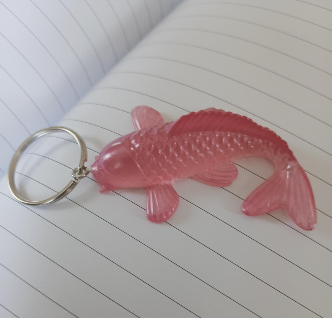 Pink resin koi fish keychain colored with mica powder.