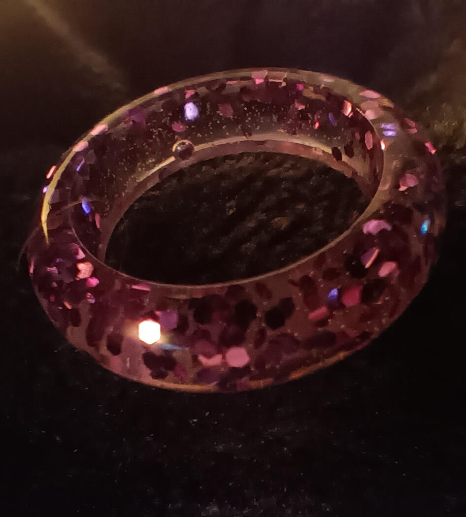 Resin ring with purple glitter.