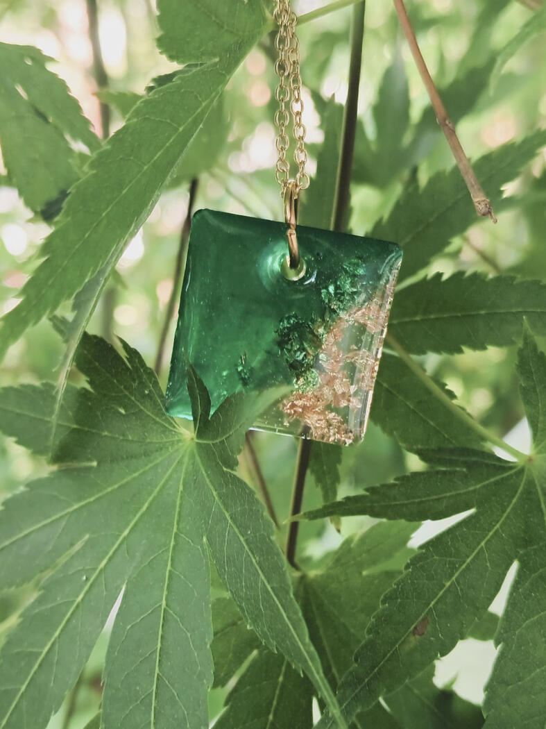 Square resin pendant with gold leaf and green alcohol ink.